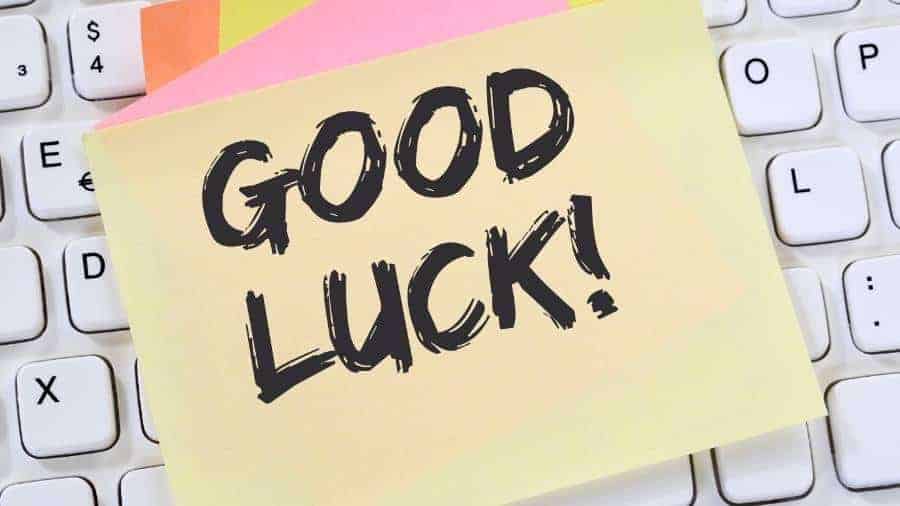 A sticky note with the message "Good Luck!" lying across a keyboard. 