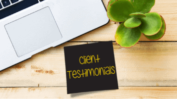 A wooden desk with a laptop, a succulent, and a black, square note that says "Client Testimonials" in yellow letters.