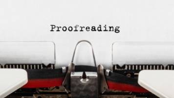 Someone has typed the word "Proofreading" on a typewriter.