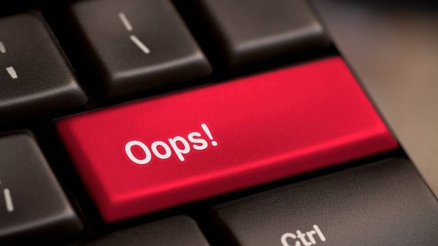 A keyboard on a laptop has a red key with the word "Oops!"