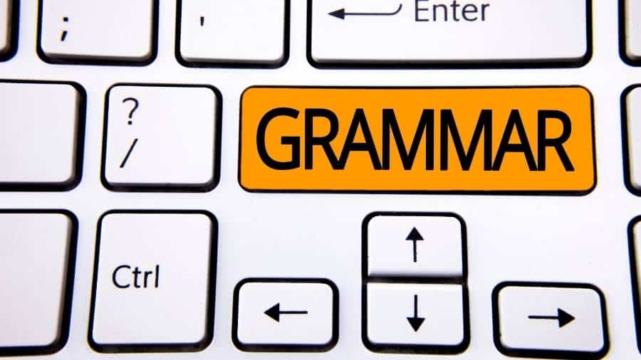 A white keyboard with a large rectangular key that has the word "Grammar" written across it. 