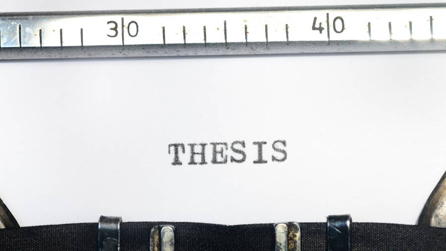 Someone has typed the word "Thesis" on a typewriter. 