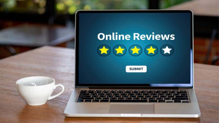 A laptop screen that says "Online Reviews" with a row of five stars underneath. Four out of the five stars are yellow. 