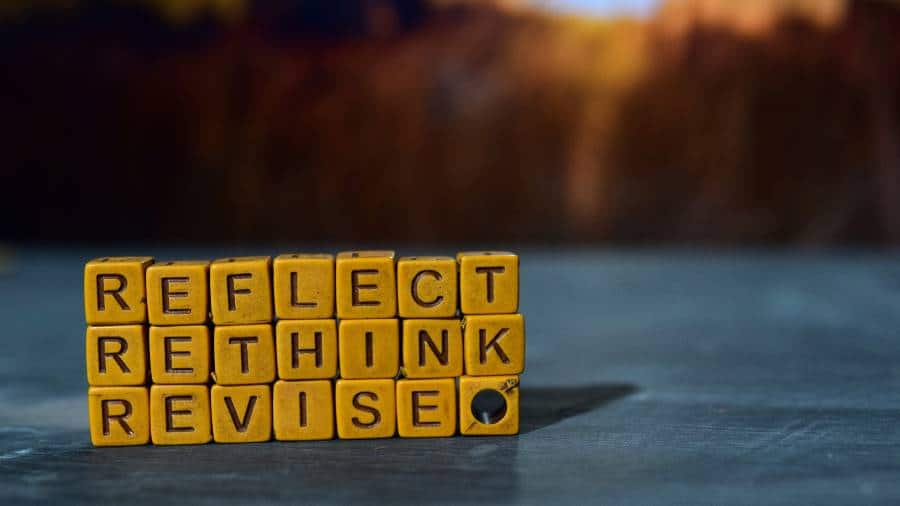 The words "Reflect," "Rethink," and "Revise" spelled in small blocks and stacked on top of one another. 