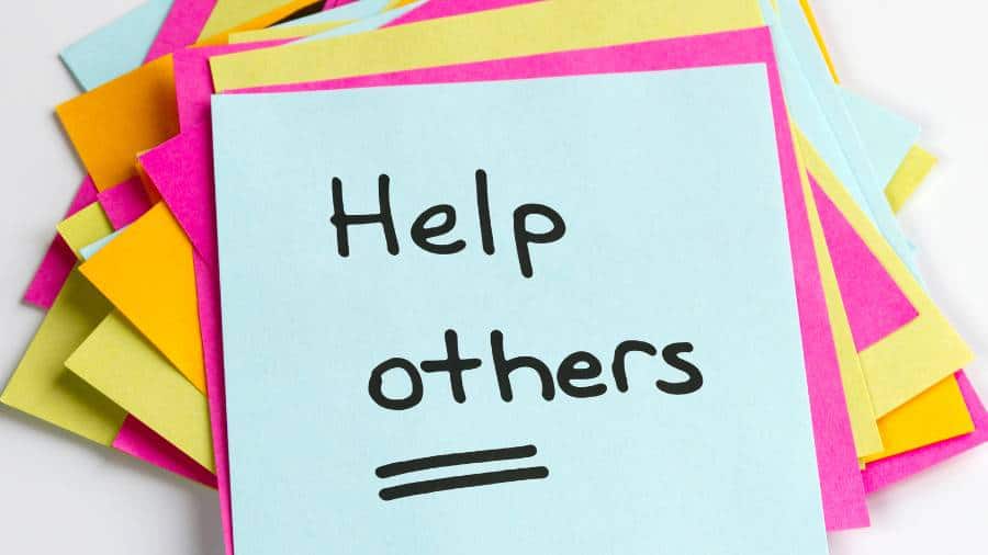 A sticky note has the message "Help others" written on it.