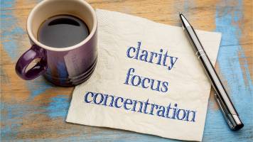 The words "clarity," "focus," and "concentration" are written on a napkin.