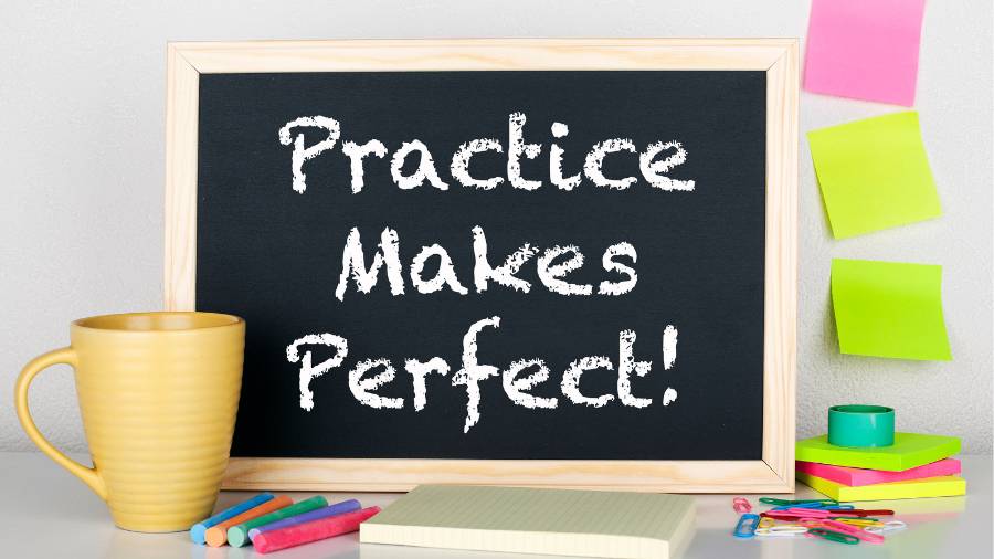 The words "Practice Makes Perfect" are written on a chalkboard. 